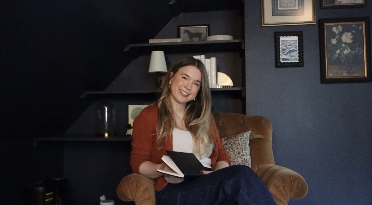 Dr. Rebekah J. sitting in a cozy chair